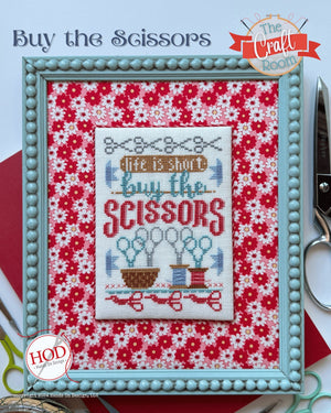 Cross-stitched design with 'Buy the Scissors' text on a floral background, framed with scissors by Hands On Design