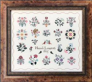 Framed cross-stitched design with floral patterns and a signature, set against a white background. Hannah Longstreth by Queenstown Sampler Designs